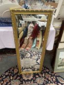 A gilt framed bevel edge mirror 37 x 97cm