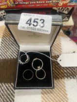 Four assorted dress rings in white metal.