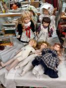 A collection of porcelain headed collectors dolls