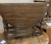 An oak drop leaf table with turned legs and solid supports. COLLECT ONLY