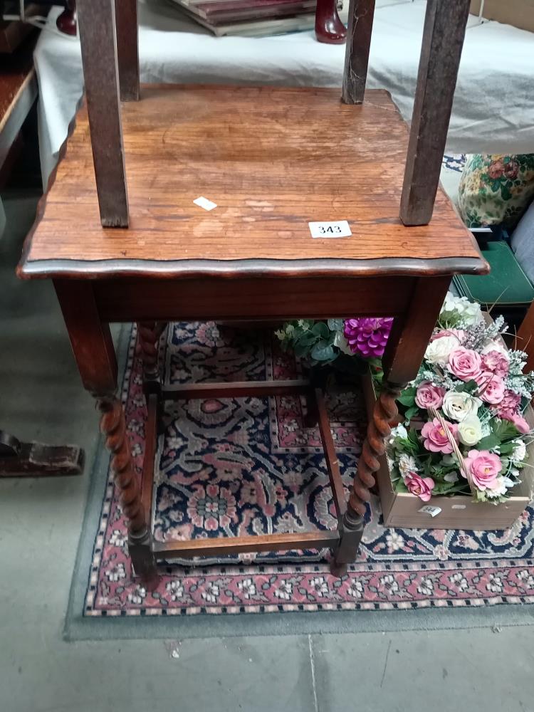 A 1930's oak side table with barley twist legs