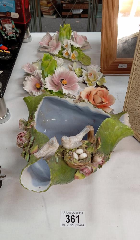A quantity of vintage floral displays including a dish with crossed swords
