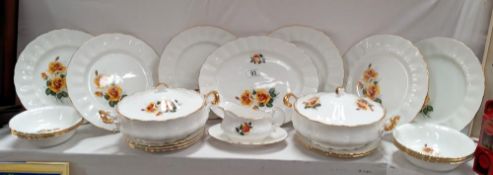 A bone china dinner set featuring yellow roses.
