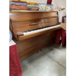 A mahogany upright piano in working condition. COLLECT ONLY