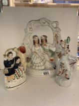 Three early 20th century Staffordshire figures.