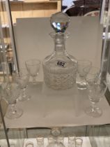 A cut glass decanter and six glasses.