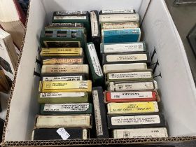 A box of 8 track cassettes