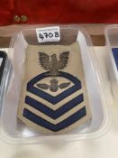 A set of military ribbons and a US Navy Boatswain's mate Chief Petty Officer bullion rate patch.