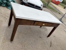 A formica topped work table with drawer