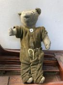 A model boat with an old teddy bear