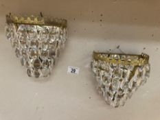 A pair of mirror back brass chandelier wall lights with glass droppers