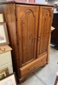A Ducal pine hall robe/cupboard with hanging rail and drawer under. COLLECT ONLY