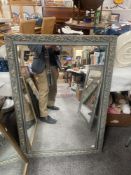 A large ornate grey gilt framed mirror 74 x 104cm