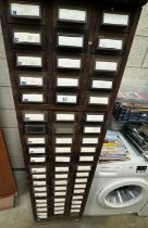 A tall wood framed cabinet of metal card filing drawers 45 x 64 x 162cm