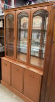 A teak effect part glazed dresser, Etched glass, interior lighting and mirror back with internal