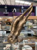 A sculpture of 2 otters fishing