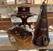 A vintage leather money box & A pottery loaf of bread money box