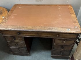 A Mahogany twin pedestal clerks desk with brown leather top comes apart to transport brass