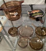 A collection of French brown glass 'Vision' cooking pots & pans