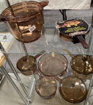 A collection of French brown glass 'Vision' cooking pots & pans