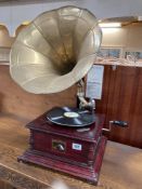 A 20th century replica of a horn gramophone with brass horn