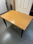 An extending modern draw leaf dining table