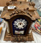 A French clock with hand painted porcelain panels, (missing hands).