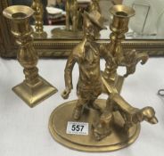 A solid brass figure of a gamekeeper with dog & A pair of candlesticks with pushers