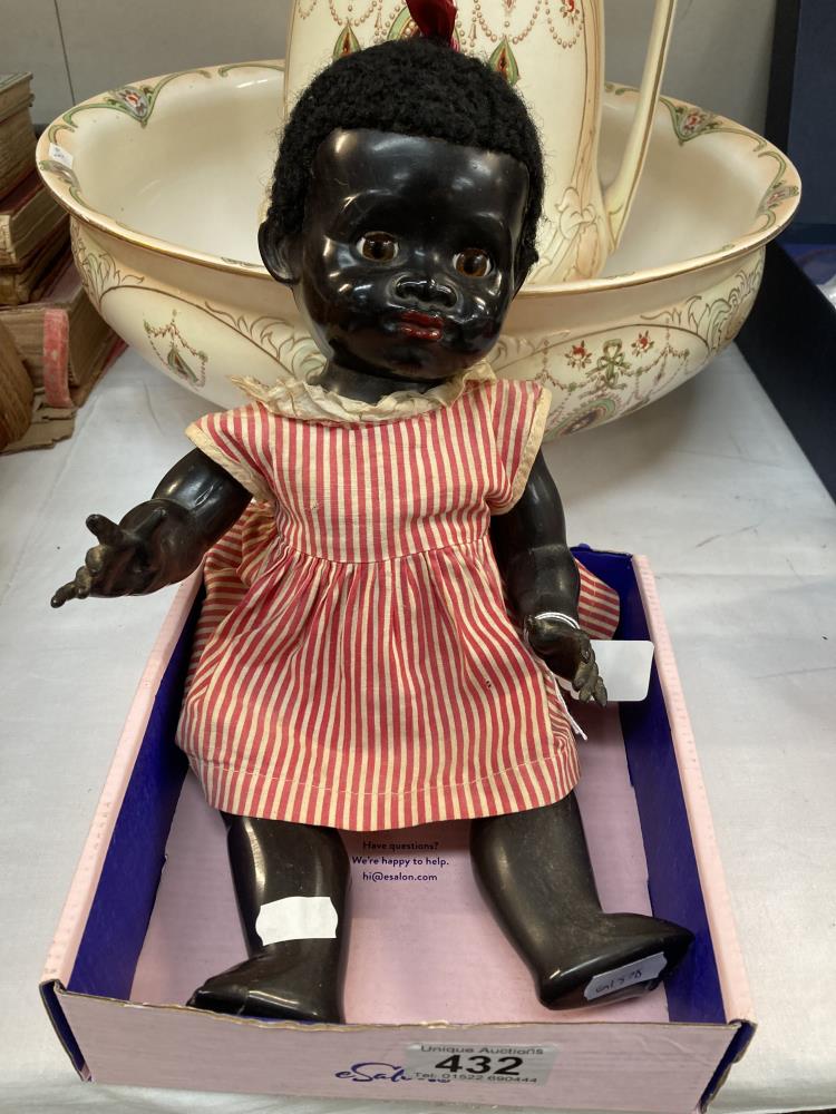 A vintage Pedigree black baby doll