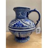 A blue glazed stoneware jug