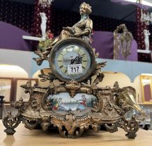 A French spelter mantel clock with hand painted panel with porcelain panel and face filled with