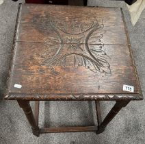 A carved oak occasional table.
