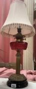 A Victorian oil lamp converted to electric. Crack to font.