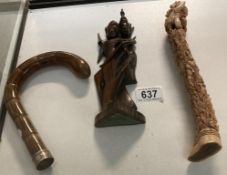An oriental carved bone statue, A silver beaded brolly handle & A carved wooden figure