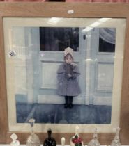 A large framed print of a girl. 70 x 70cm