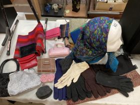 A selection of scarfs, gloves, purse bags etc