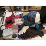 A selection of scarfs, gloves, purse bags etc