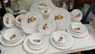 A 21 piece bone China dinner set featuring yellow roses.