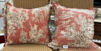 A pair of feather cushions with vintage style cushion covers