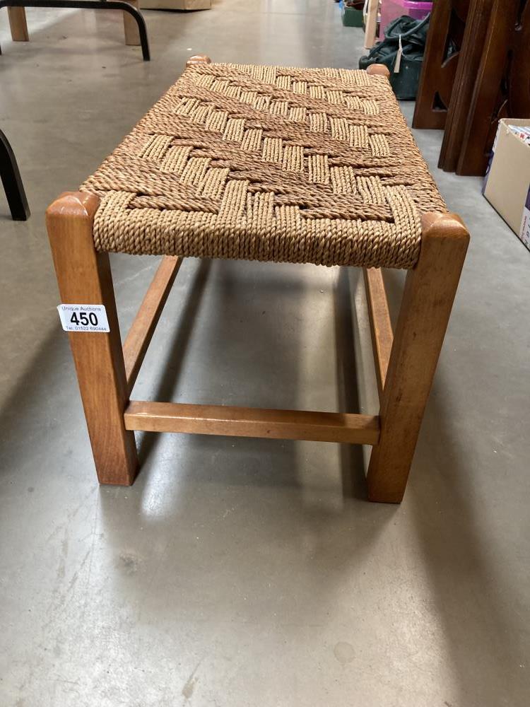 A Long foot stool with rope twist top