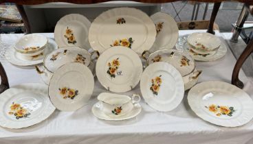 A 21-piece bone China dinner set featuring yellow roses.