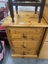 A solid pine bedside chest of drawers