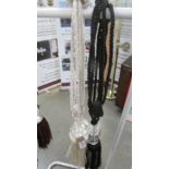 A pair of black curtain tie backs with gem / bead effect embellishment and tassels and a pair of