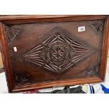 A large star-burst carved serving tray with ornate metal handles