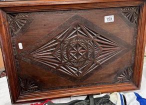 A large star-burst carved serving tray with ornate metal handles