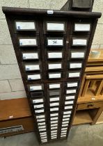 A tall wood framed cabinet of metal card filing drawers 45 x 64 x 162cm