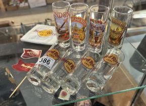 A collection of hard rock cafe glasses & reused items
