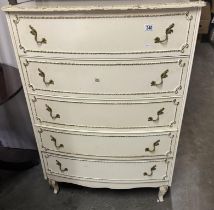 A white bow fronted chest of drawers
