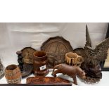 A quantity of wooden carved items including Plaques, eagle, cat candlestick holder etc