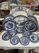 A quantity of blue & white dinner ware in blue willow & A blue & white ceramic meat plate